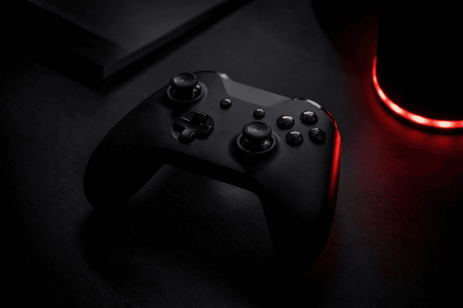 Xbox controller in a dark gaming setup